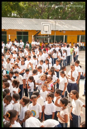 children standing in court during the assembly at CEBRH in Utila, Honduras.